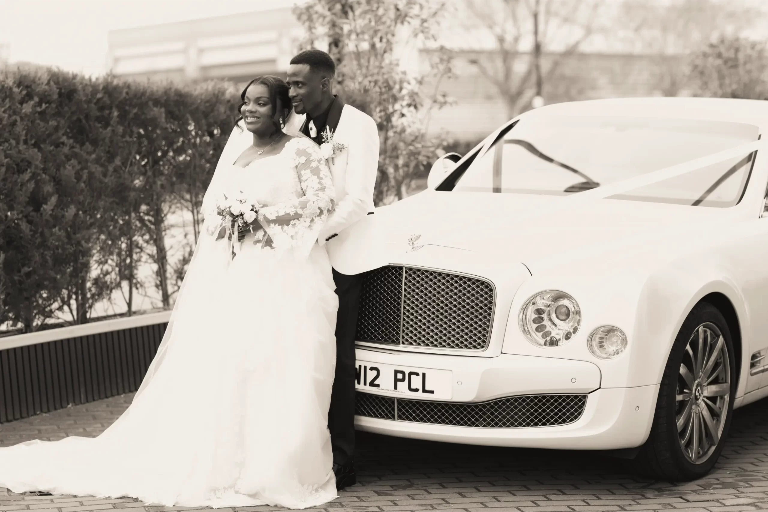 a bride and groom and a car