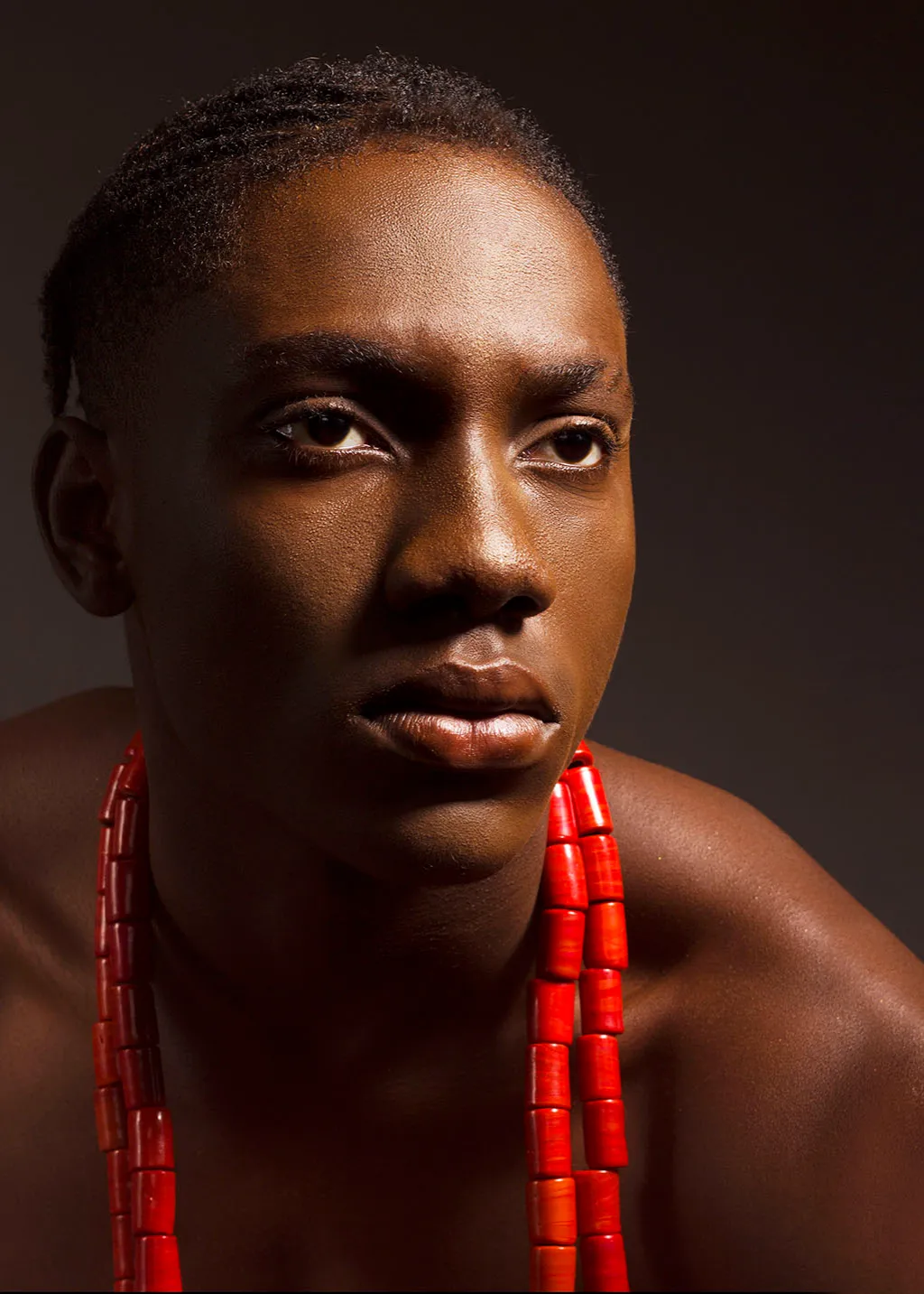 african man headshot with beaded neckless