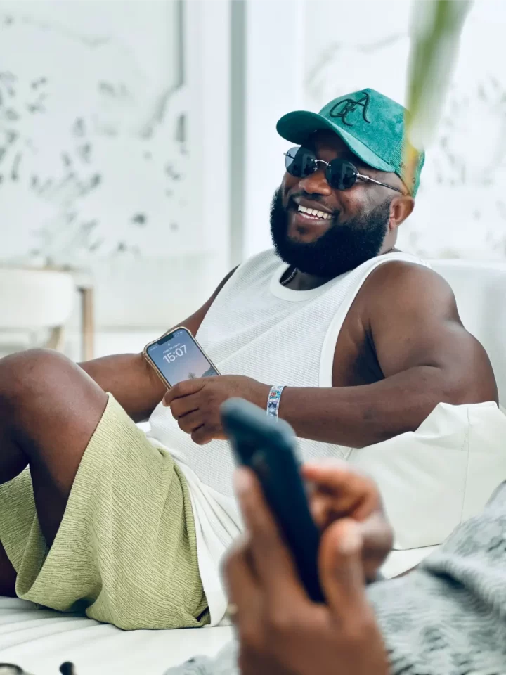 a man smilling with his phone