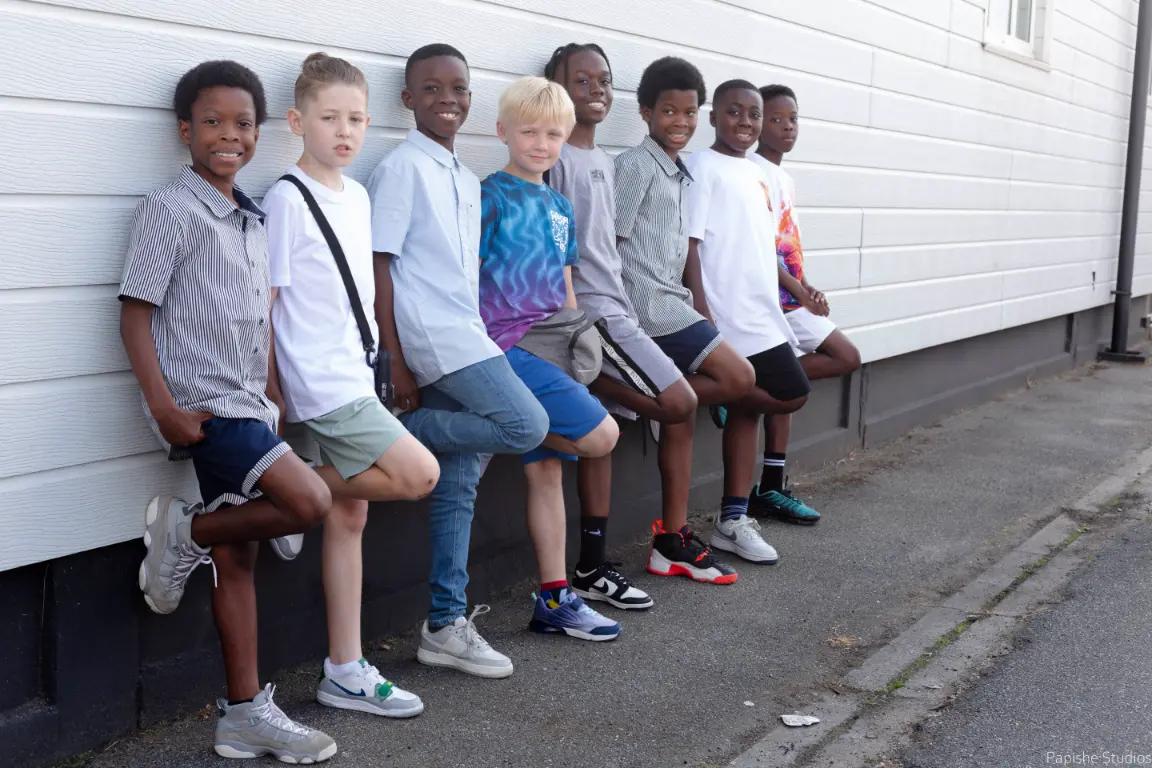 boys leaning on a wall